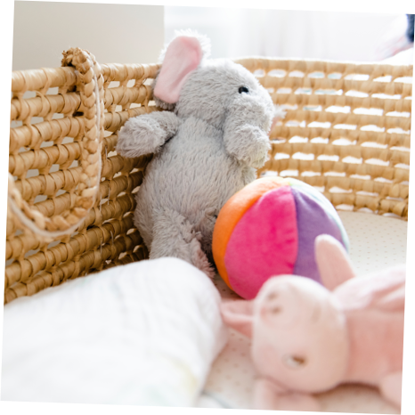 A selection of cuddly toys are shown in a baby's cot