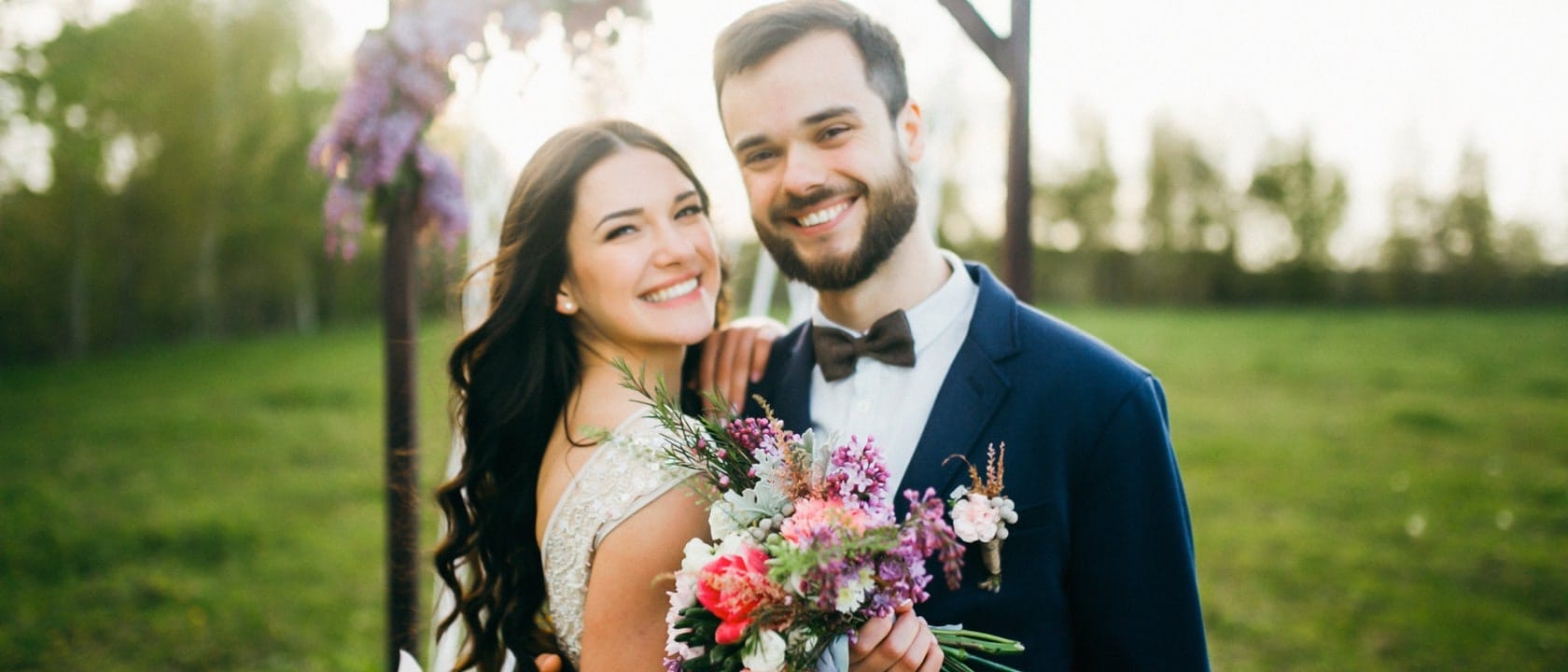 Two people on their wedding day with flowers