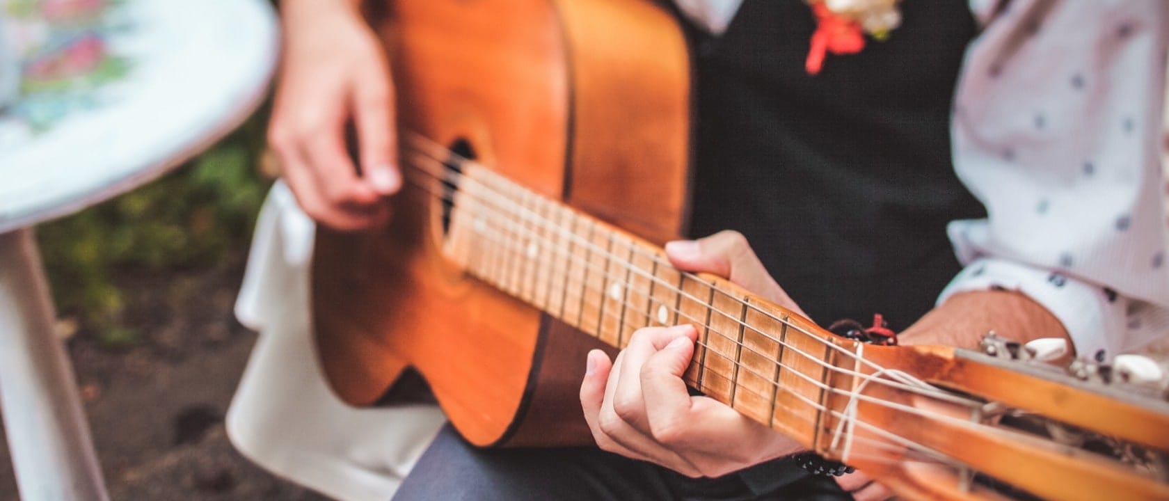 Man playing guitar while wearing a suit