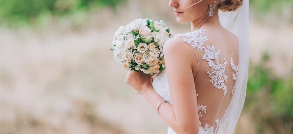 Woman carrying flowers on her wedding day