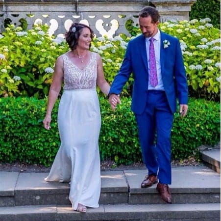 Man and woman holding hands on their wedding day