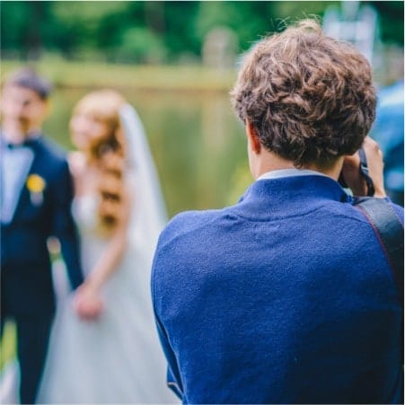 Photographer takes pictures of the bridge and groom