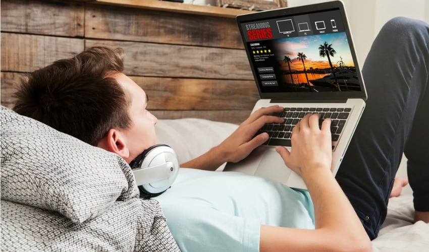 Man watching TV on laptop