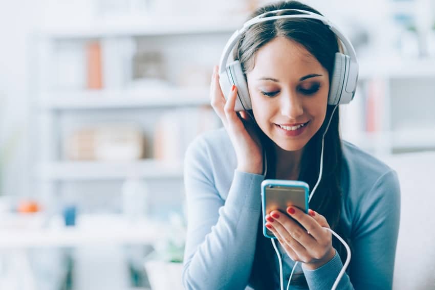 Woman using subscriptions to listen to music