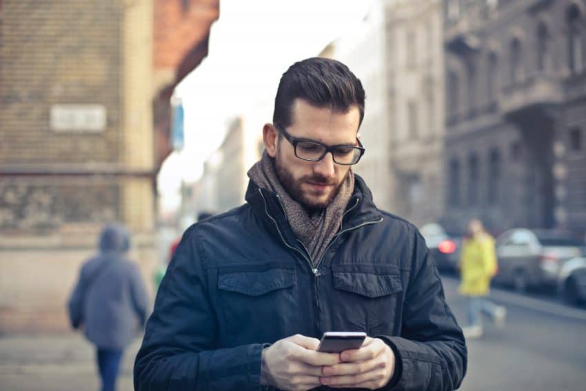 man using smartphone to simplify your life