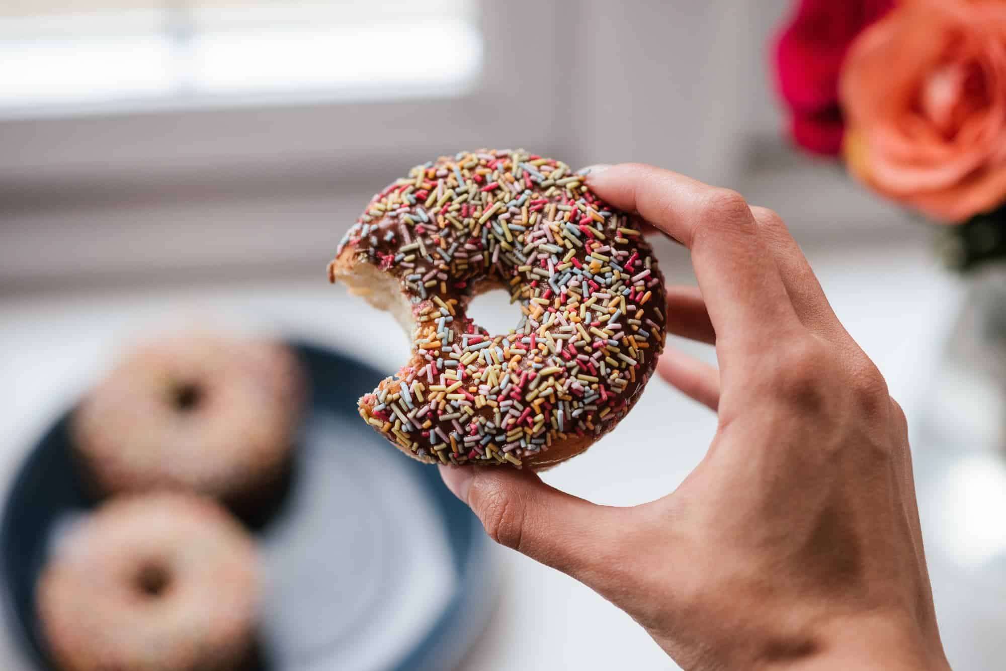 Ring donut with sprinkles with a bite out of it