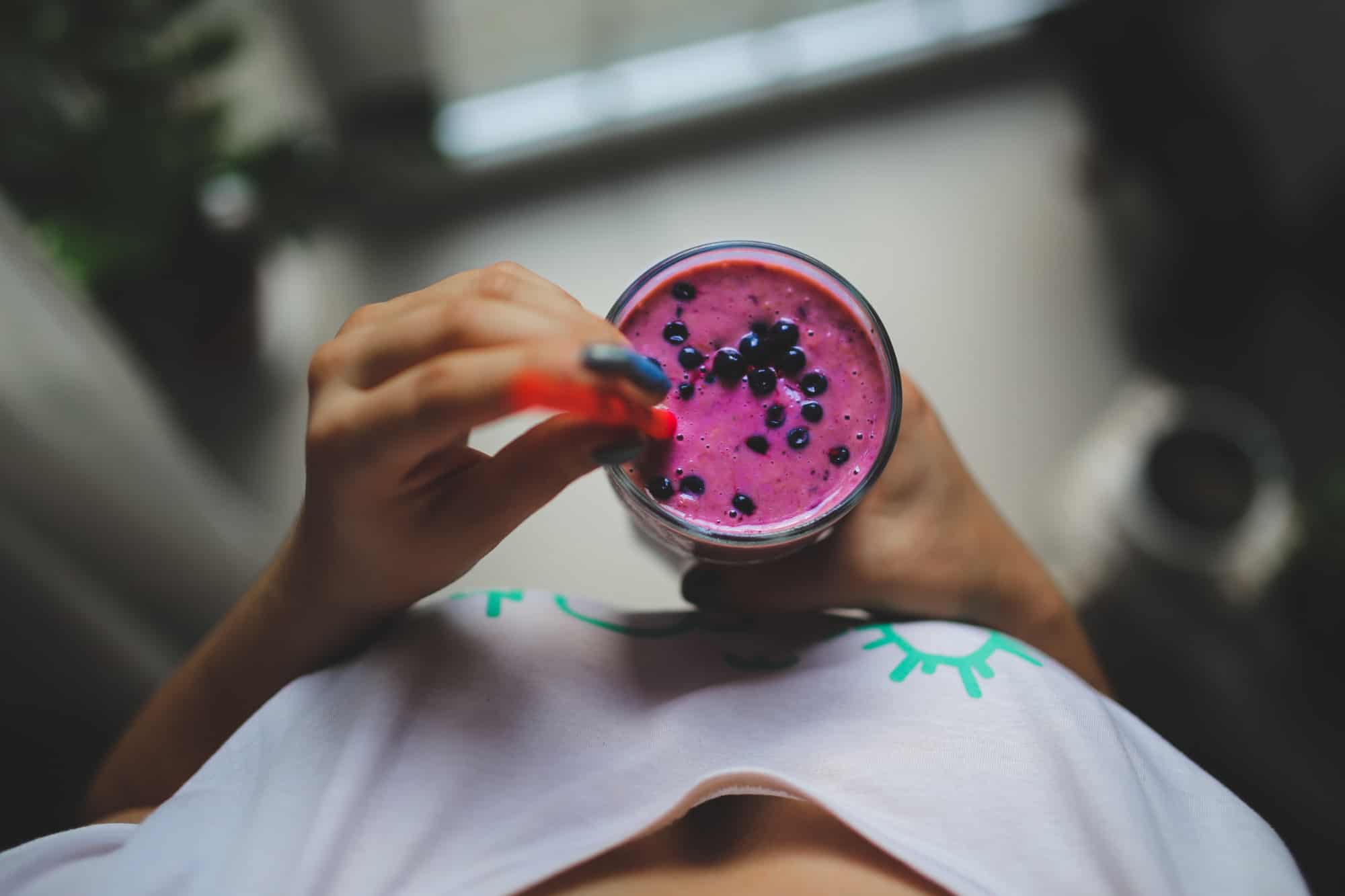 blueberry smoothie being held 