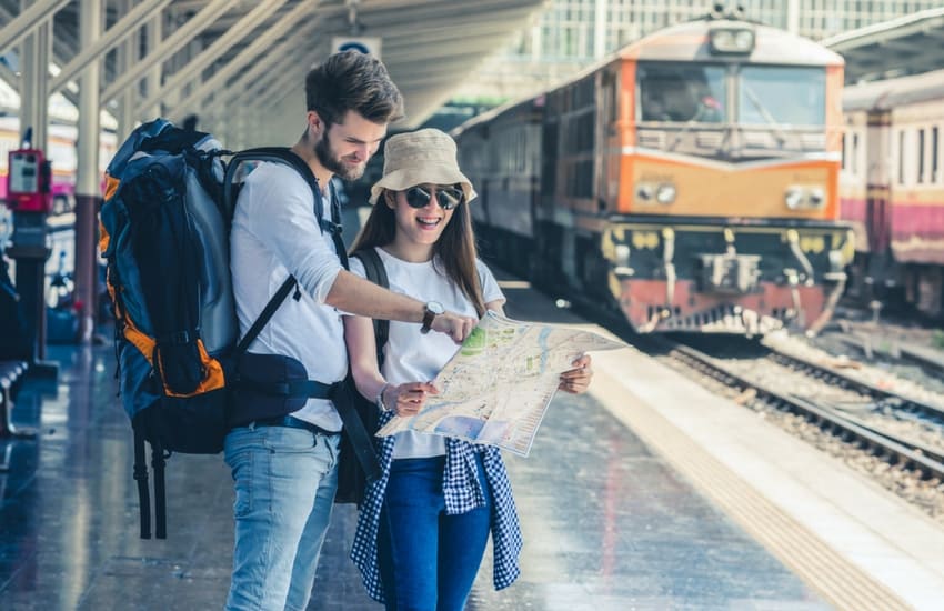 Couple checking map at train station