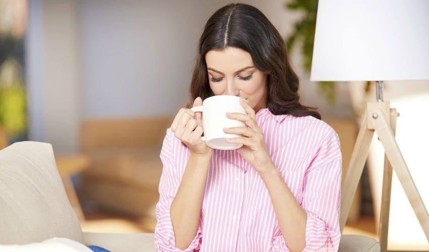 Woman drinking chamomile tea