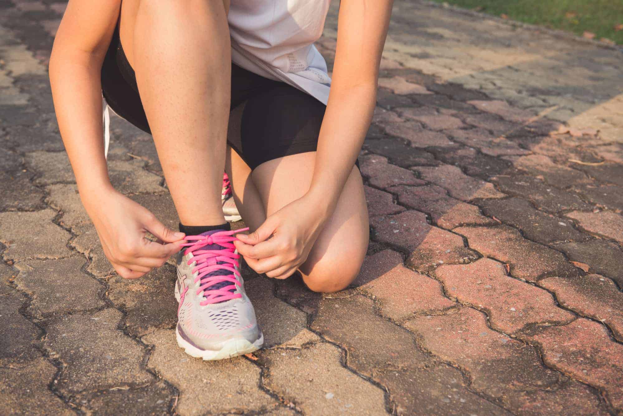 woman tying running shoes