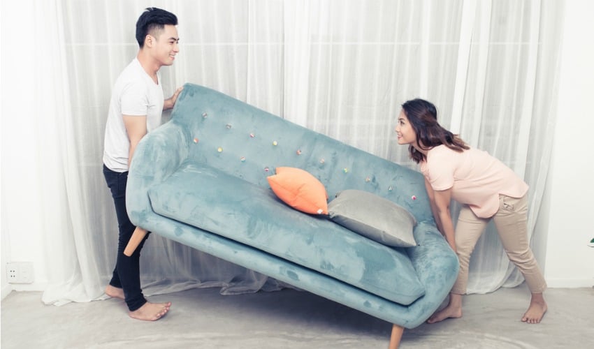 Image of couple moving sofa for home makeovers