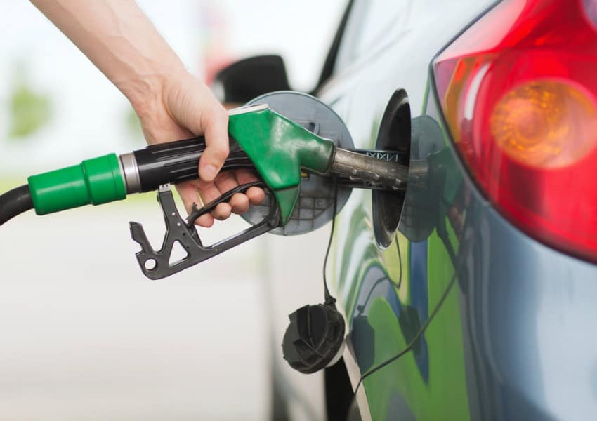 Close up of person putting petrol in car