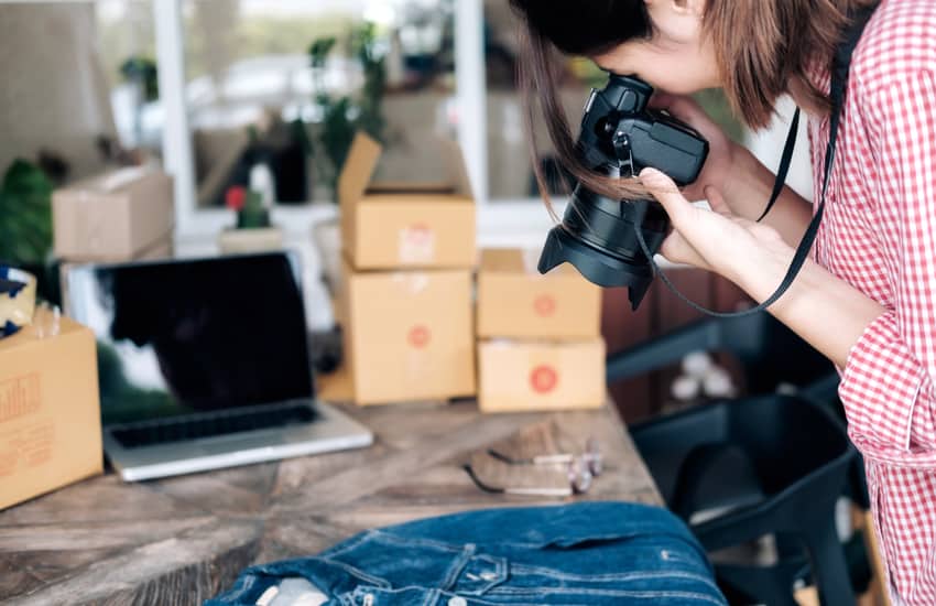 Woman photographing clothing to sell online