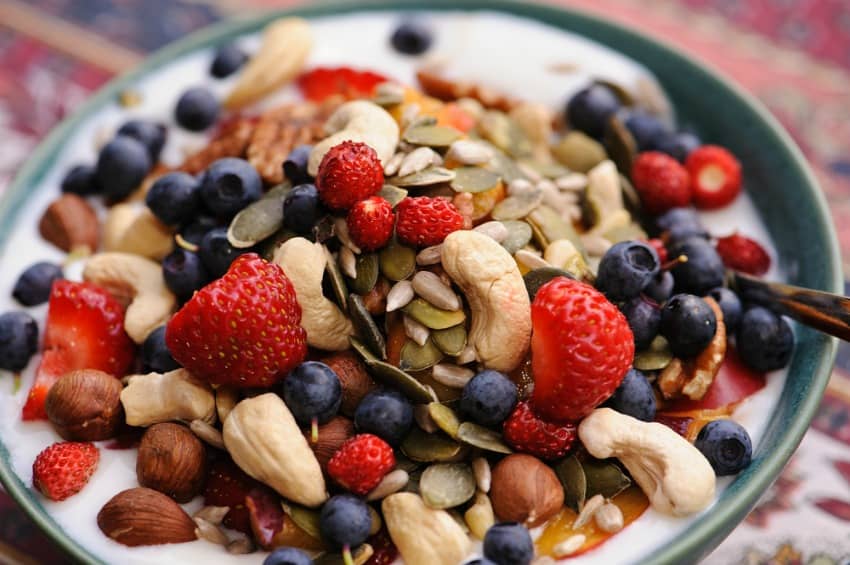 An image showing yoghurt with berries and seeds