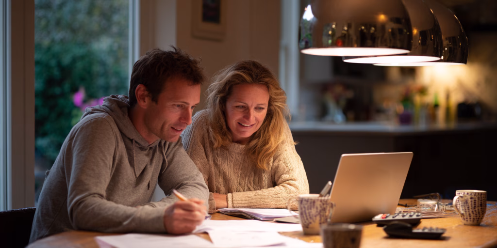 couple comparing 24 hour loan options on tablet at home in UK
