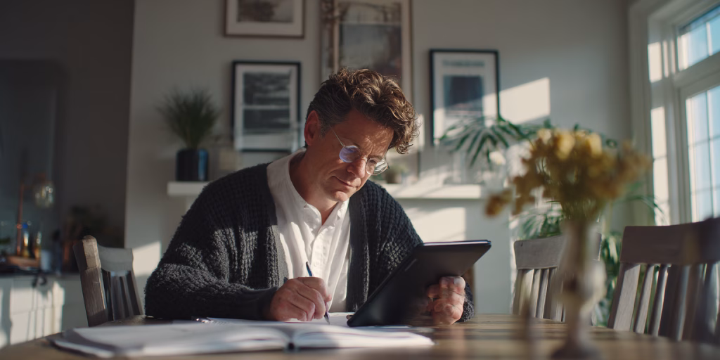 man comparing 200 pound loan alternatives on laptop in UK home