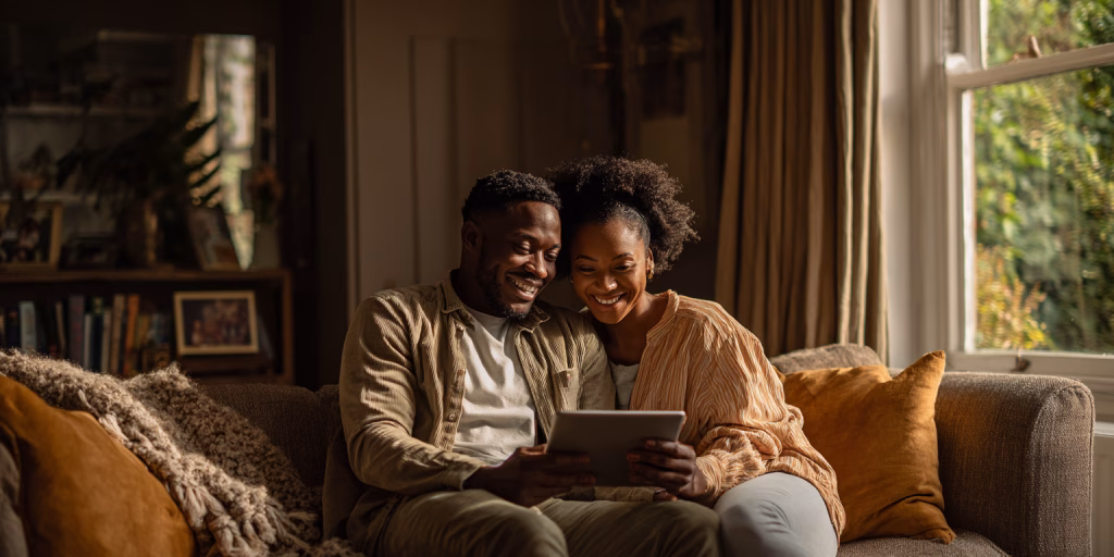 couple reviewing emergency loan alternatives on tablet in UK home