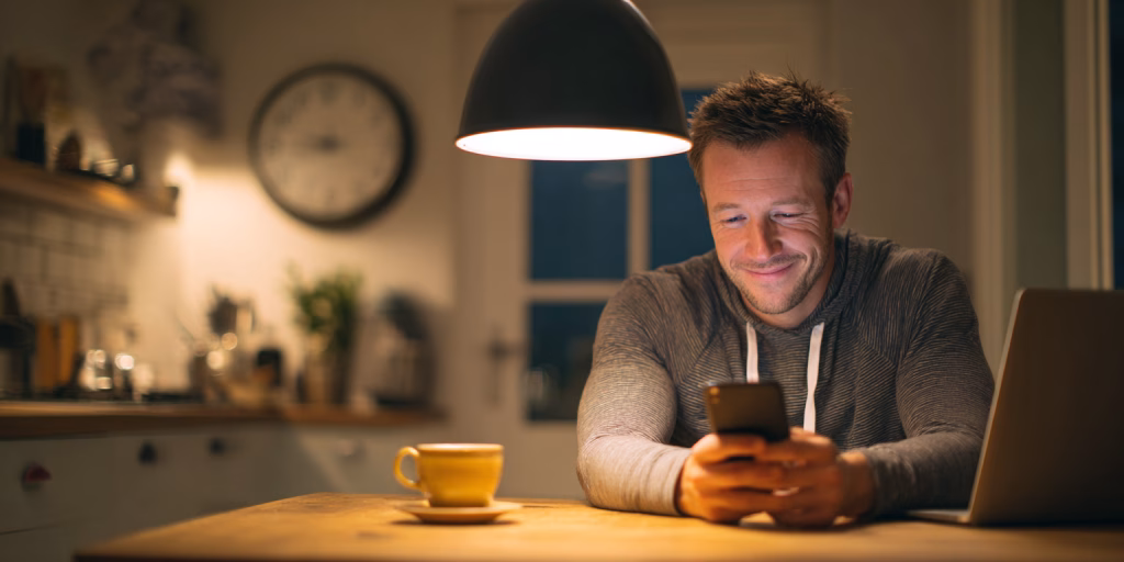 Person checking 24 hour loan approval on phone at home in UK