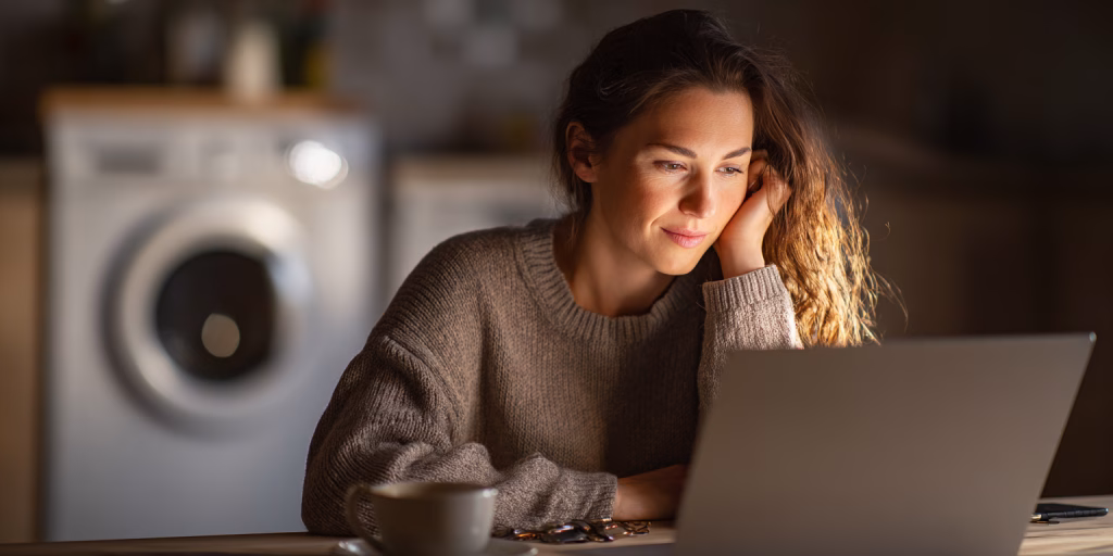 British woman reviewing small loan options for washing machine repair at home