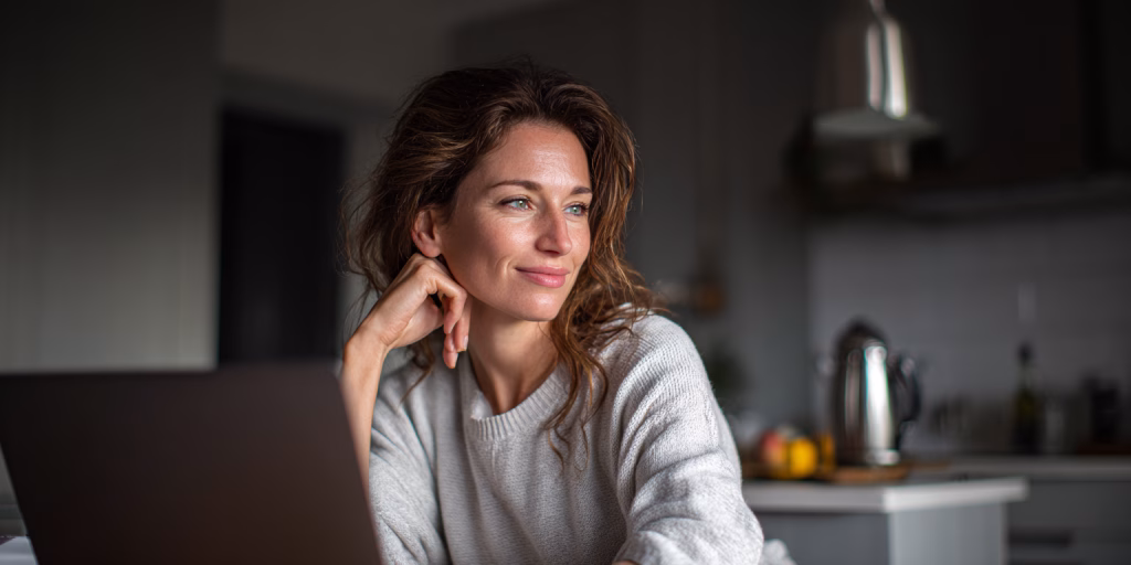 Woman comparing quick loan options on laptop in modern UK home