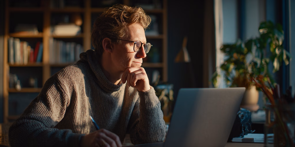 Customer comparing different loan term options on laptop in UK home